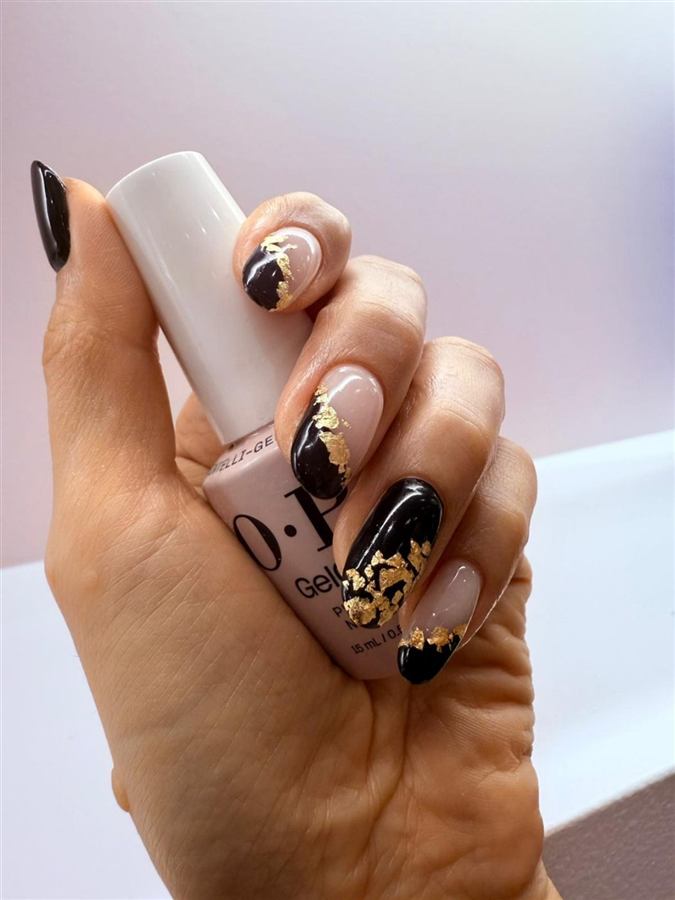 Customer manicure with black and gold nail art